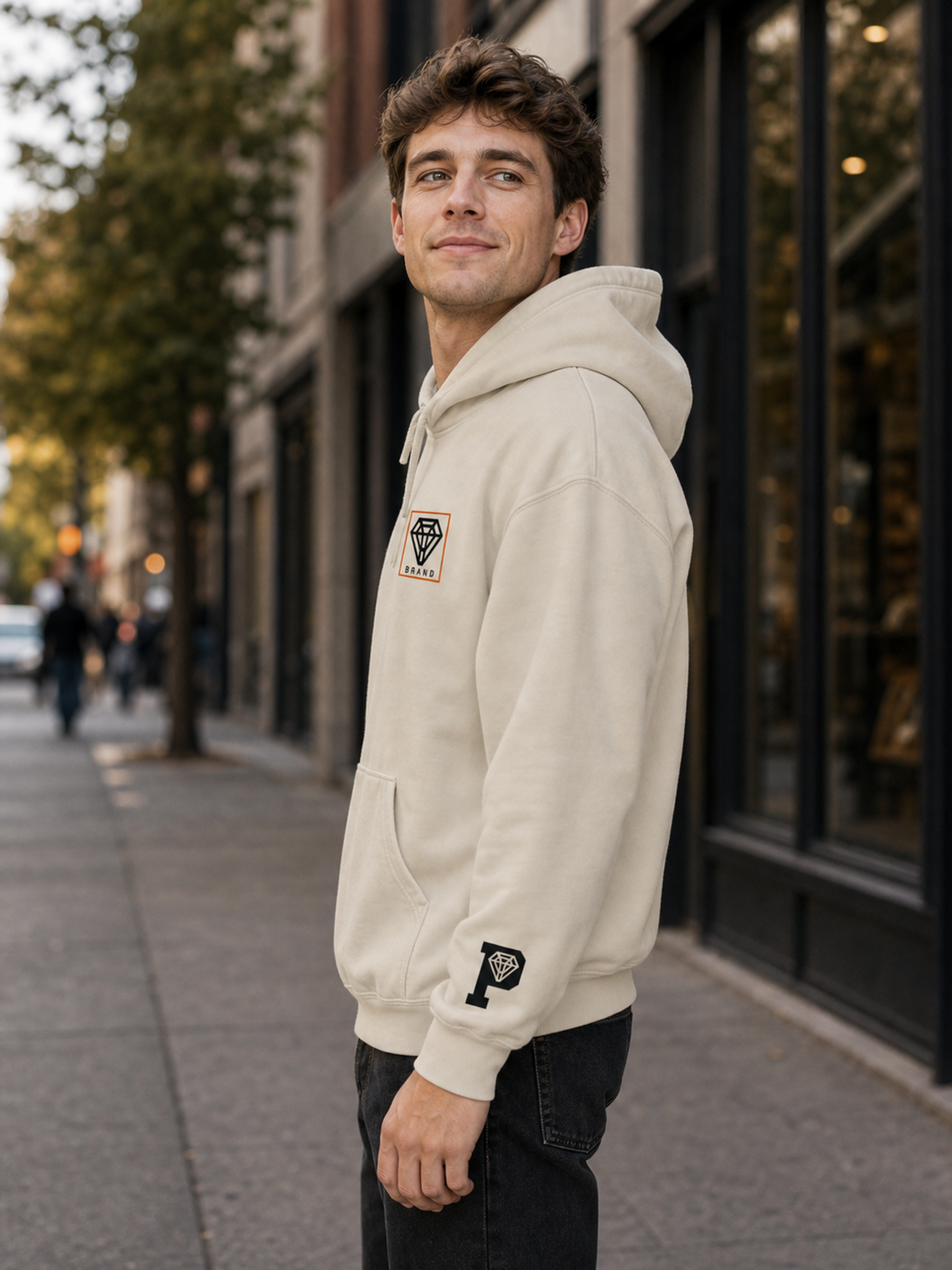 Signature Logo Hoodie in Sand left side lifestyle product image showing sleeve icon
